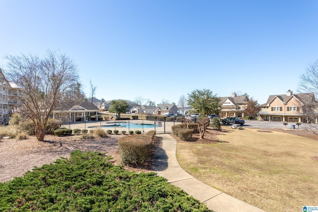 exterior space featuring fence, a residential view, and a fenced in pool