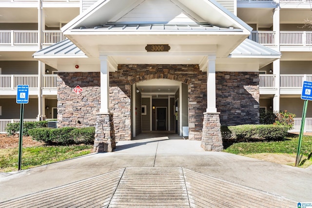 doorway to property featuring a standing seam roof and metal roof