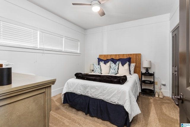 bedroom with light colored carpet, ceiling fan, and baseboards