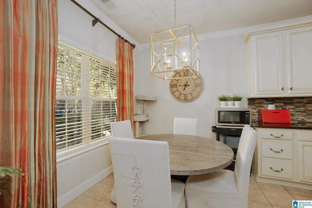 dining space with an inviting chandelier and light tile patterned flooring