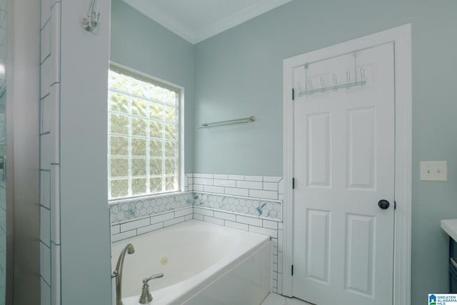 bathroom featuring ornamental molding, vanity, and a tub with jets