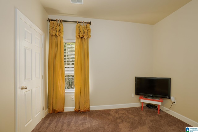 interior space featuring carpet floors, visible vents, and baseboards