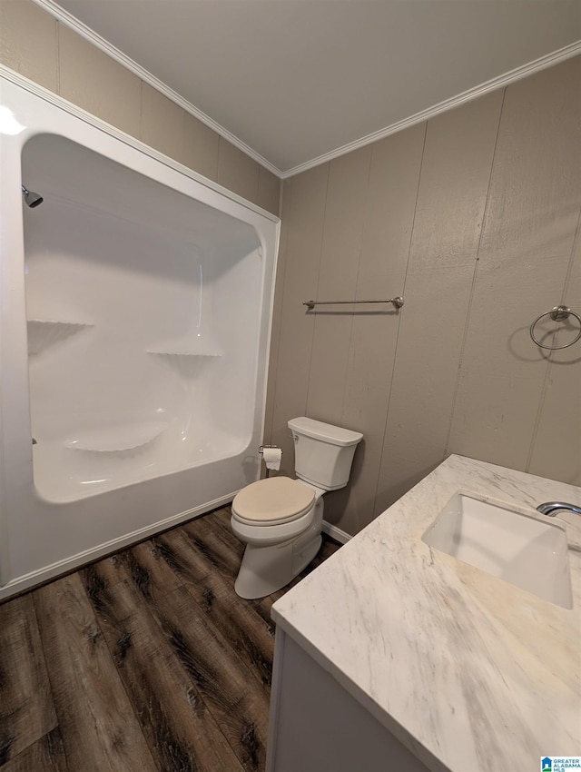 bathroom with hardwood / wood-style flooring, vanity, crown molding, and toilet