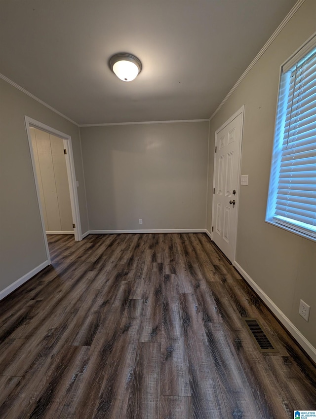 interior space with plenty of natural light, crown molding, and dark hardwood / wood-style flooring