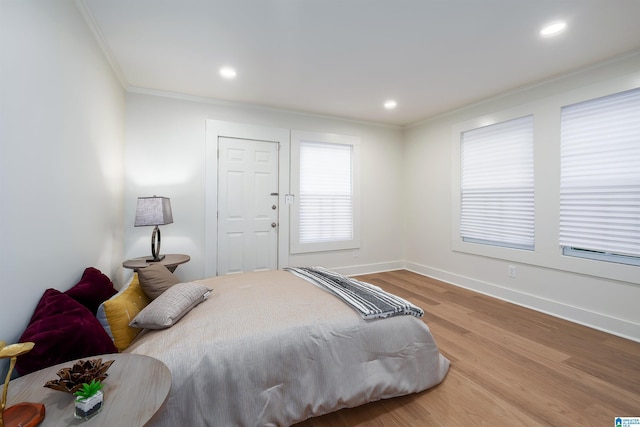 bedroom with baseboards, ornamental molding, wood finished floors, and recessed lighting