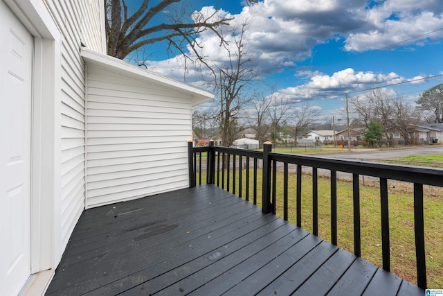 deck with a lawn and a residential view