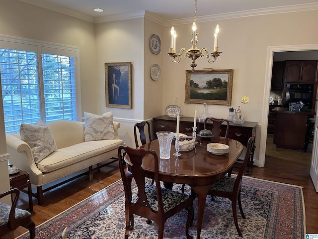 dining room featuring ornamental molding, wood finished floors, and an inviting chandelier