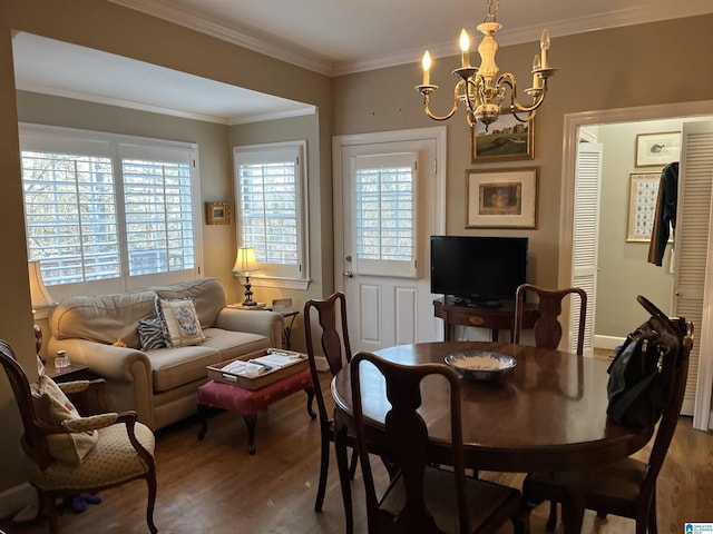 dining room featuring an inviting chandelier, ornamental molding, and wood finished floors