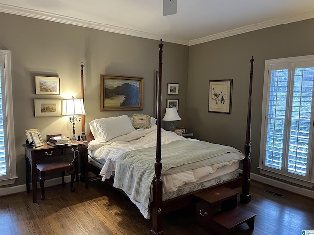 bedroom featuring crown molding, multiple windows, baseboards, and wood finished floors