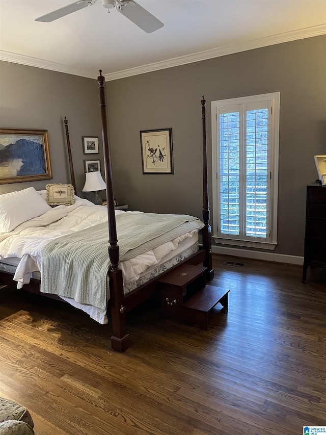 bedroom with a ceiling fan, crown molding, baseboards, and wood finished floors