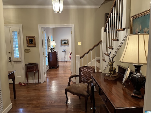 foyer entrance featuring ornamental molding, baseboards, and wood finished floors