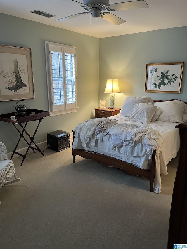 carpeted bedroom featuring ceiling fan and visible vents