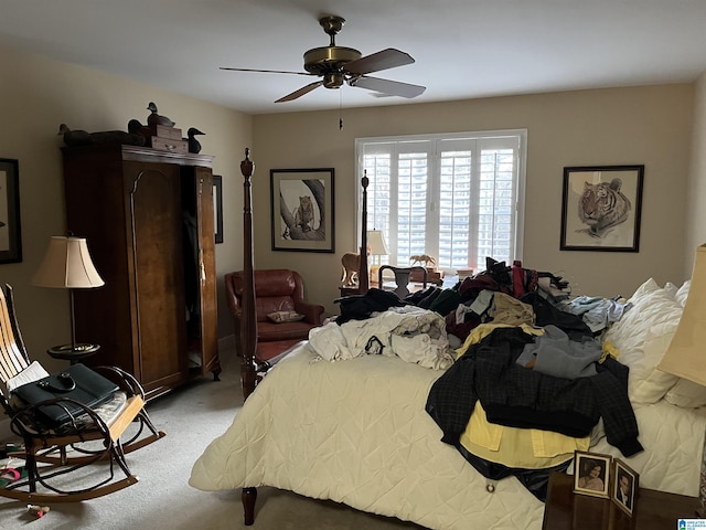 bedroom with a ceiling fan and light carpet