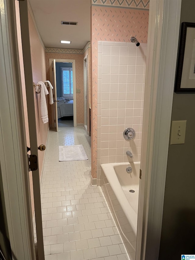 bathroom with visible vents, tub / shower combination, ensuite bath, tile patterned flooring, and wallpapered walls