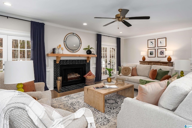 living room with ceiling fan, recessed lighting, a fireplace, light wood finished floors, and crown molding