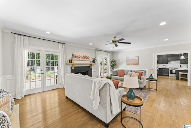 living area featuring a wealth of natural light, french doors, and wood finished floors