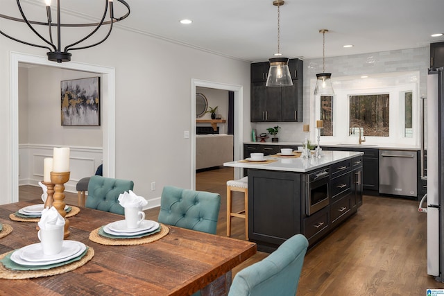 dining room with a wainscoted wall, ornamental molding, dark wood-style flooring, and recessed lighting