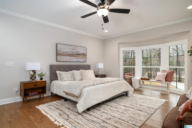 bedroom with baseboards, dark wood-type flooring, recessed lighting, and crown molding