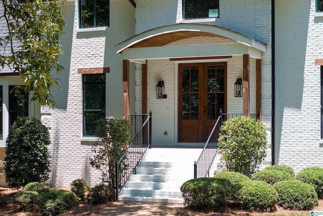 entrance to property featuring brick siding