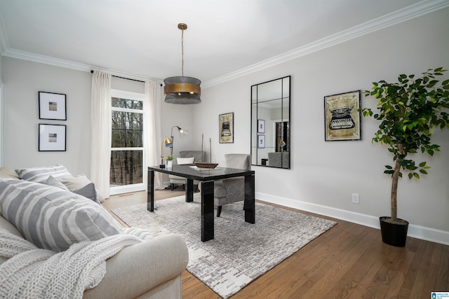 office space featuring ornamental molding, baseboards, and wood finished floors