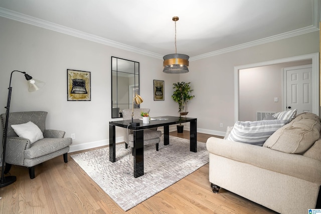 office area with crown molding, light wood-style flooring, visible vents, and baseboards