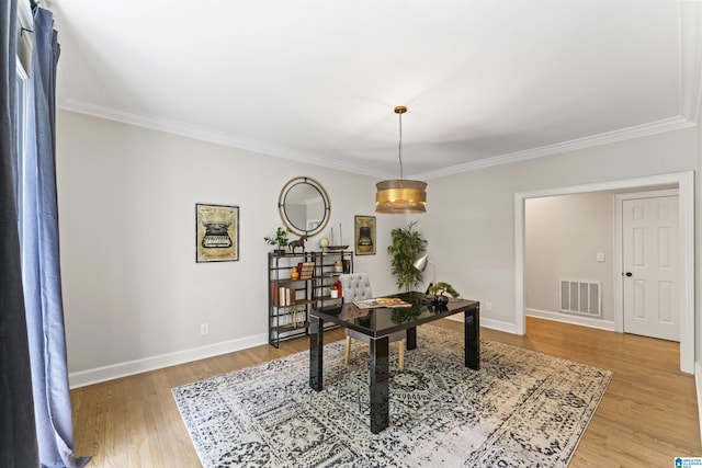 home office featuring baseboards, ornamental molding, visible vents, and light wood-style floors