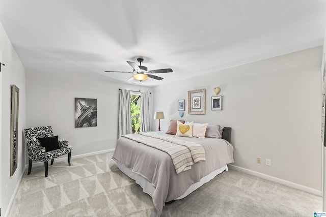 bedroom with baseboards, ceiling fan, and light colored carpet