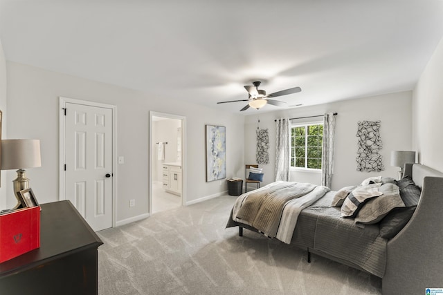 bedroom featuring ceiling fan, baseboards, connected bathroom, and light colored carpet