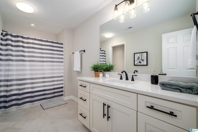 full bathroom featuring curtained shower, tile patterned flooring, vanity, and visible vents