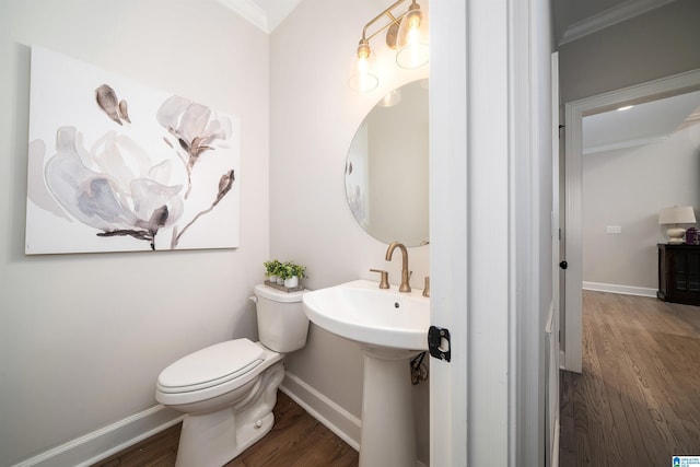 half bathroom with toilet, baseboards, and wood finished floors