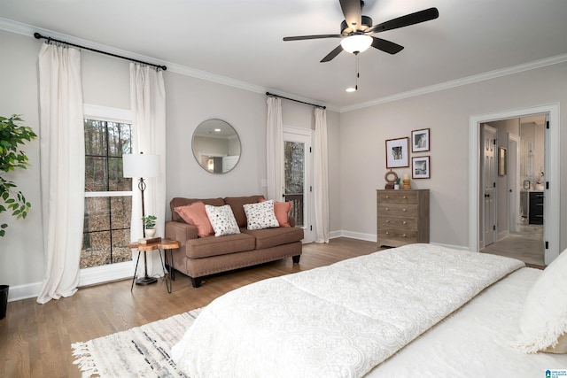 bedroom with baseboards, wood finished floors, and crown molding