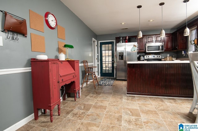 kitchen with kitchen peninsula, dark brown cabinets, stainless steel appliances, and decorative light fixtures