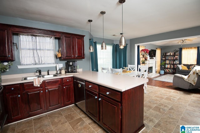 kitchen with sink, dishwasher, ceiling fan, kitchen peninsula, and hanging light fixtures