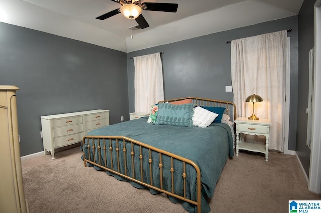 carpeted bedroom featuring ceiling fan and lofted ceiling