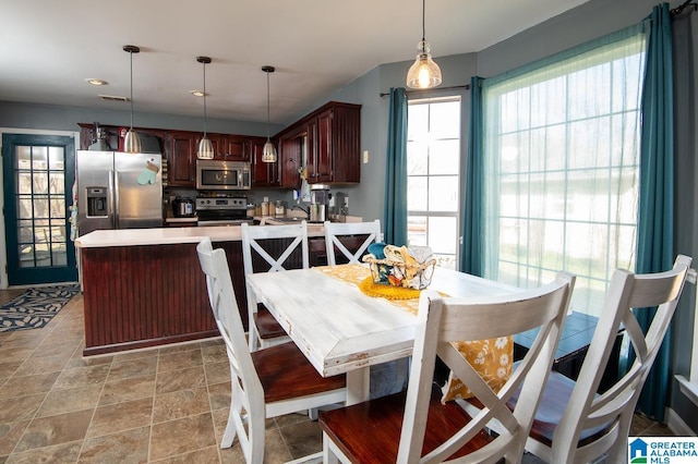 kitchen with stainless steel appliances and hanging light fixtures