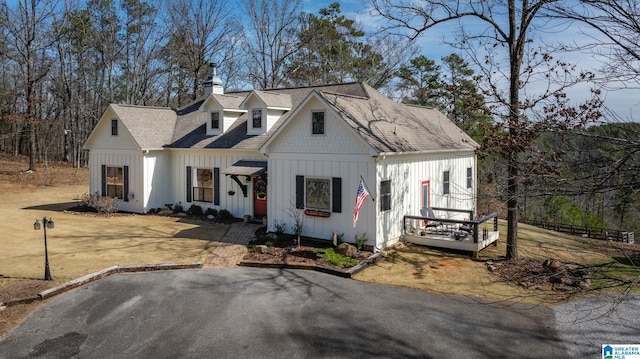 view of front of home with a chimney and board and batten siding