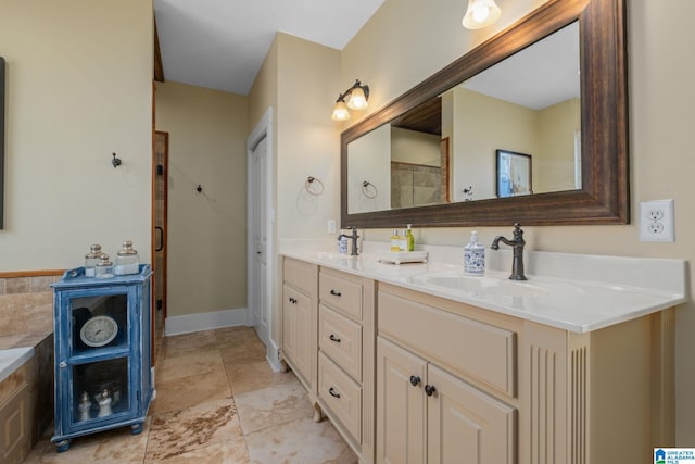 full bath featuring walk in shower, a sink, baseboards, and double vanity