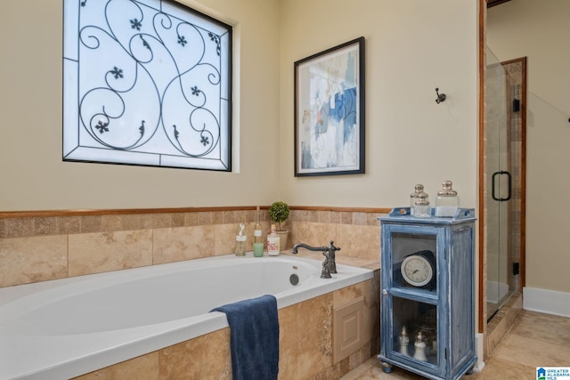 bathroom featuring a stall shower, a bath, and tile patterned floors