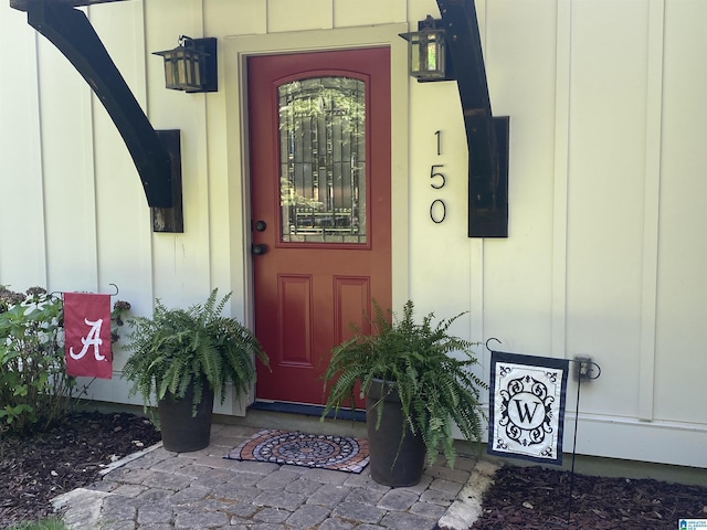 view of exterior entry featuring board and batten siding