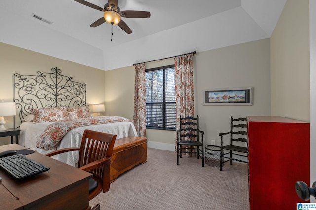 carpeted bedroom with baseboards, visible vents, vaulted ceiling, and a ceiling fan