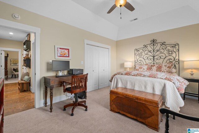 carpeted bedroom with a closet, visible vents, and ceiling fan