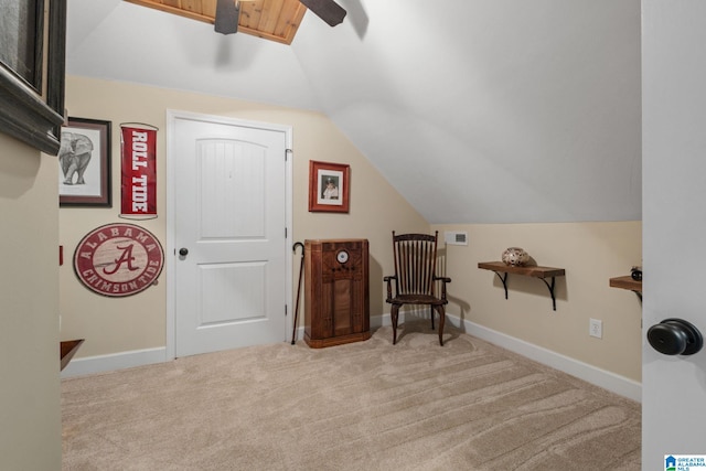 sitting room with lofted ceiling, visible vents, baseboards, and carpet flooring