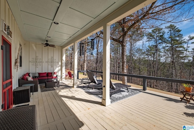 deck with a ceiling fan and an outdoor living space