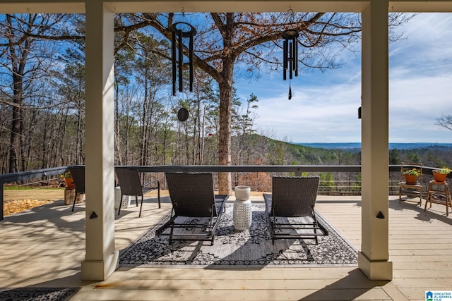 wooden terrace with a view of trees