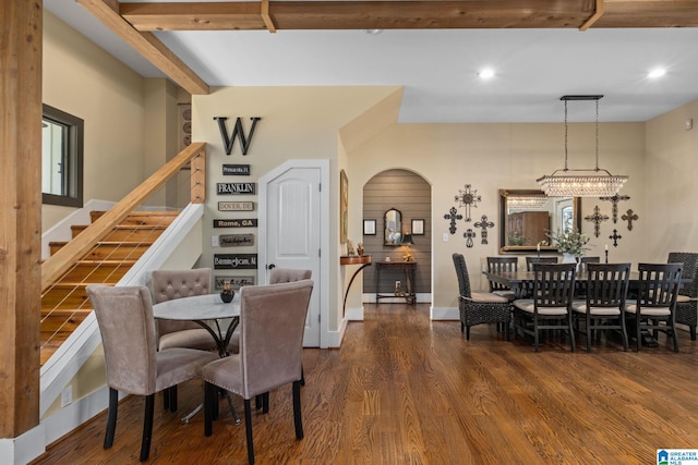 dining space with arched walkways, recessed lighting, wood finished floors, baseboards, and stairs