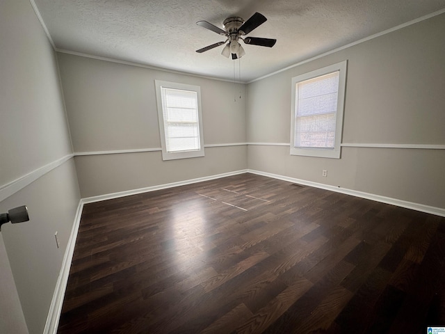 empty room featuring a textured ceiling, ornamental molding, and dark wood-type flooring