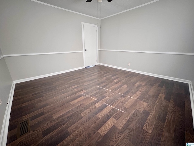 spare room with ceiling fan, baseboards, dark wood finished floors, and crown molding