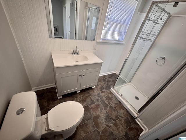 bathroom with toilet, vanity, heating unit, stone finish flooring, and a stall shower