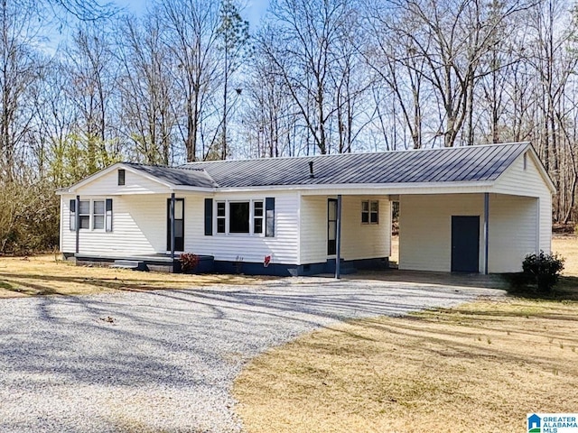 ranch-style home featuring crawl space, driveway, and metal roof