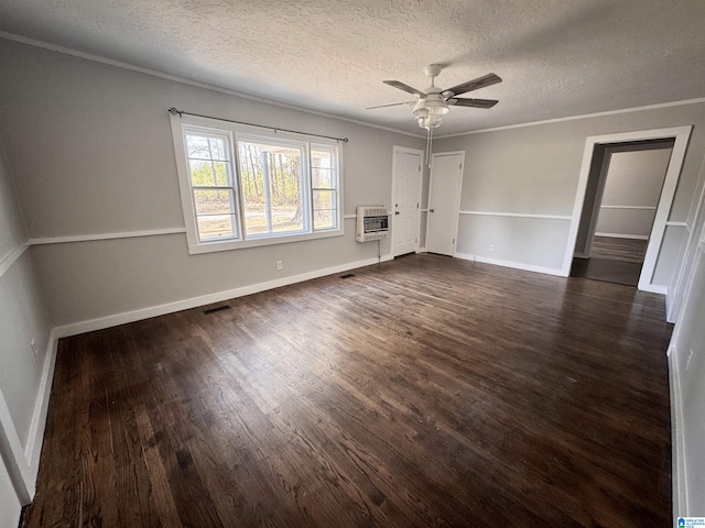 unfurnished room with ornamental molding, dark wood finished floors, visible vents, and baseboards